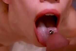PIGTAILED CUTIE TAKES THICK LOAD ON HER OUTSTRETCHED PIERCED TONGUE CLOSEUP
