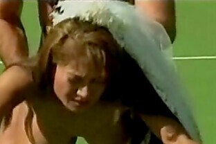 Asian bride on a tennis court