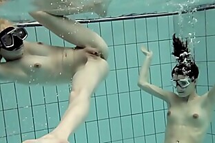 Girls swimming underwater and enjoying eachother