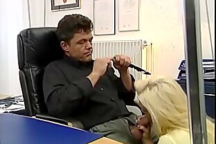 Sexy blonde gives a blow job under the desk of her boss