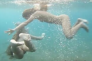 Julia and Masha are swimming nude in the sea