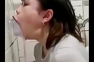 Asian deepthroating a dildo